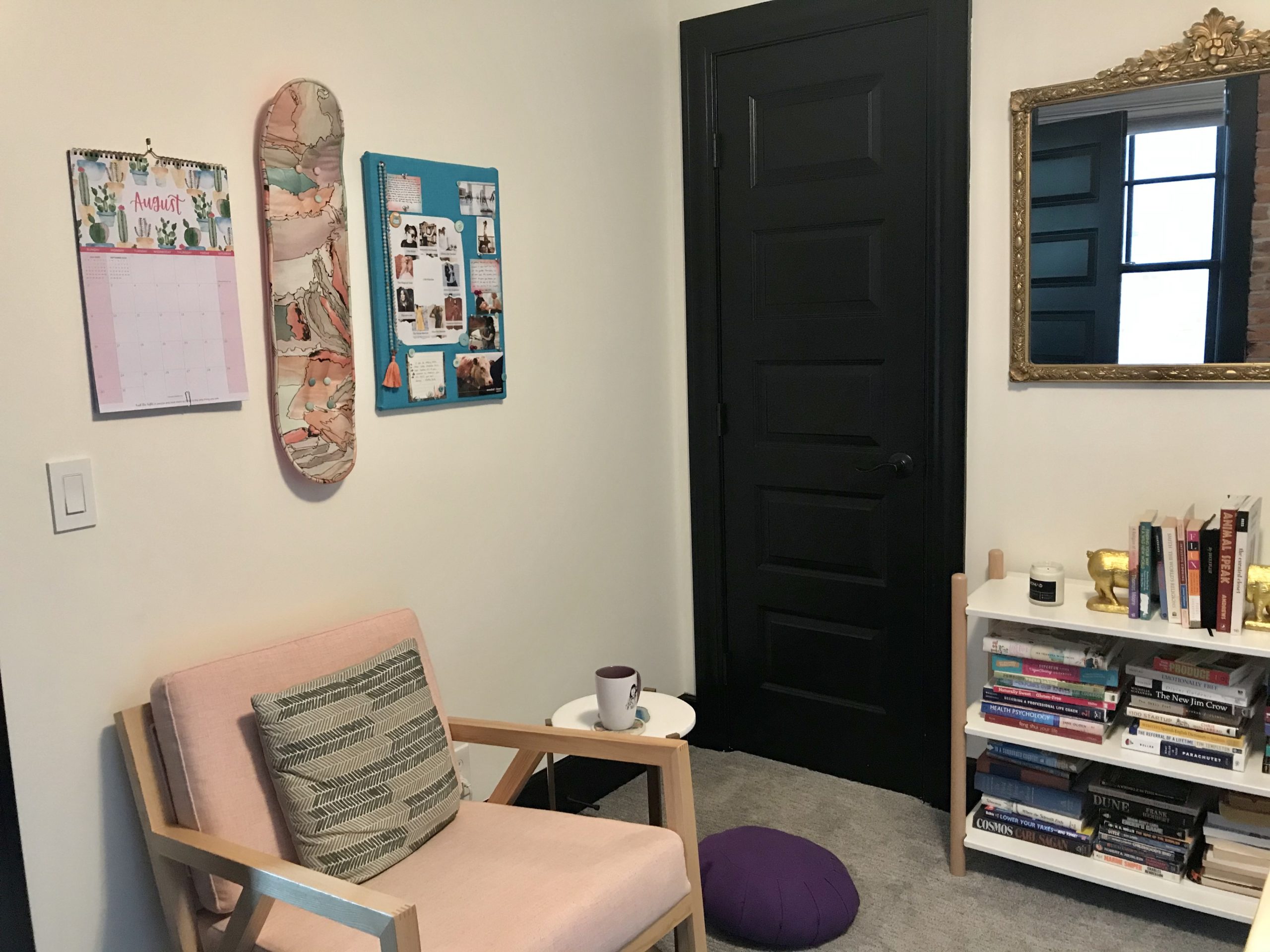 my home office with DIY materials like a calendar, books, and a vision board