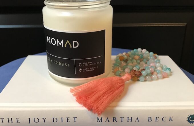 Nomad candle and Mala Collective beads on The Joy Diet book